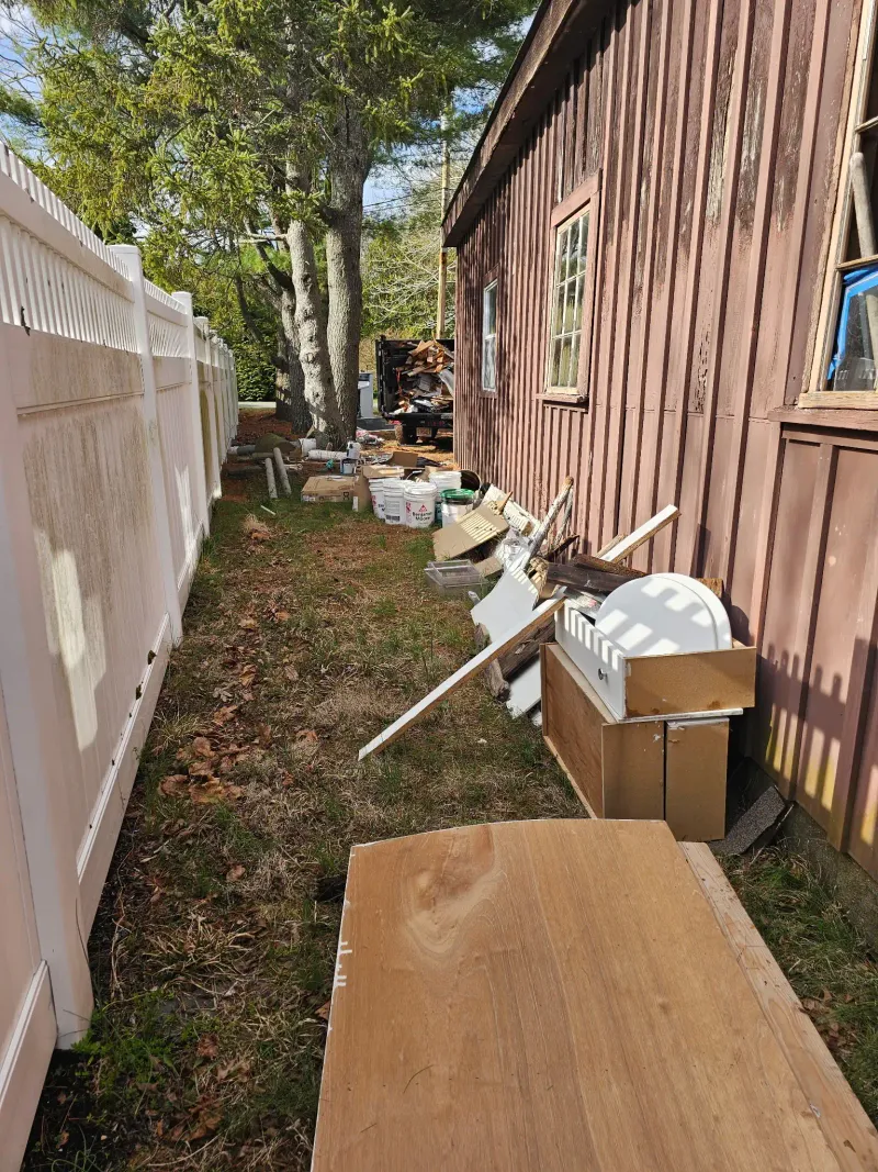 Side yard junk and debris piled up for removal near Wareham MA