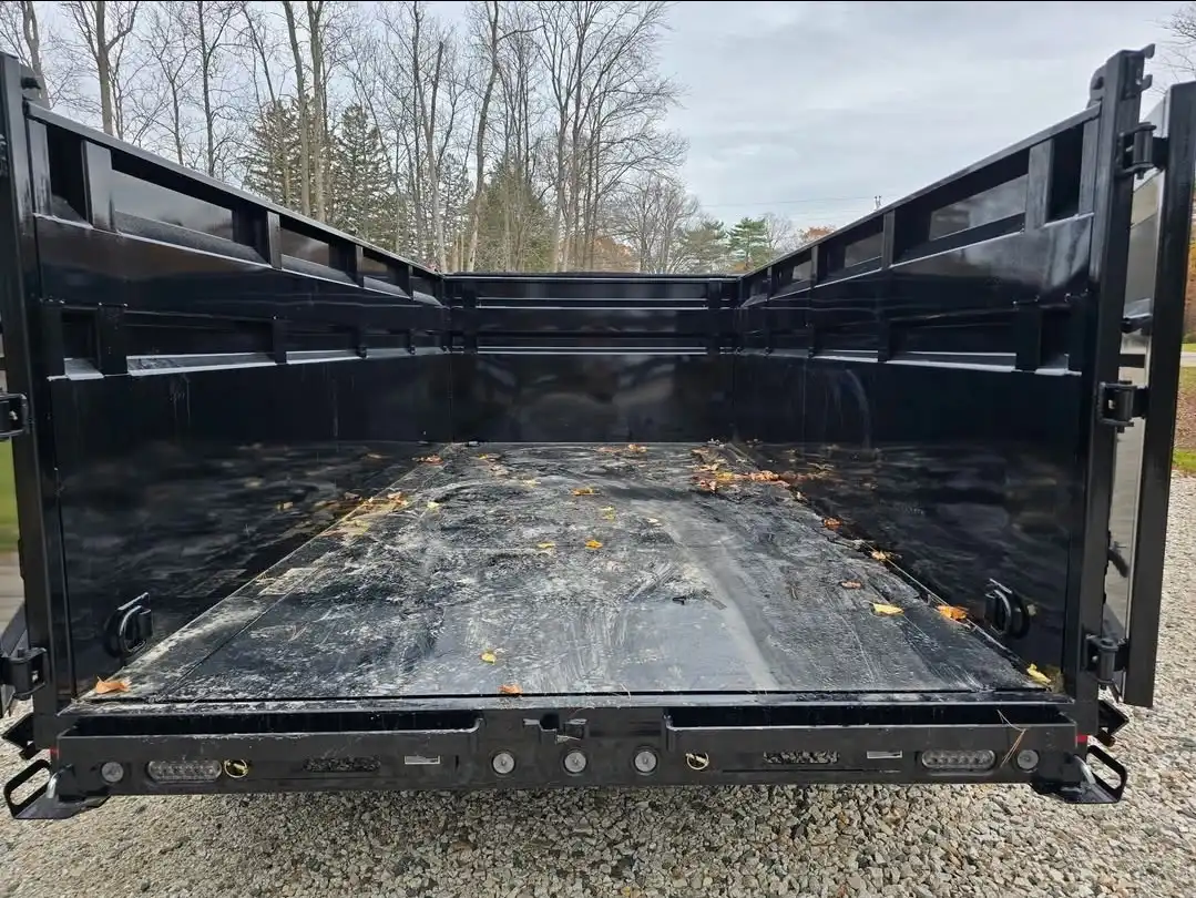 Empty dump trailer delivered to a residential driveway