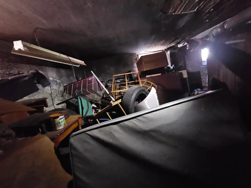 Cluttered basement full of stored items before cleanout service near Wareham