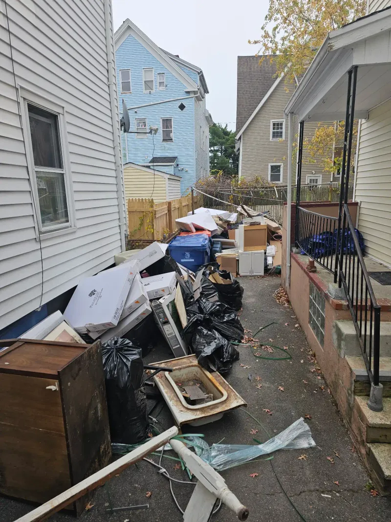 Driveway cleanout with furniture boxes and bags near Wareham MA