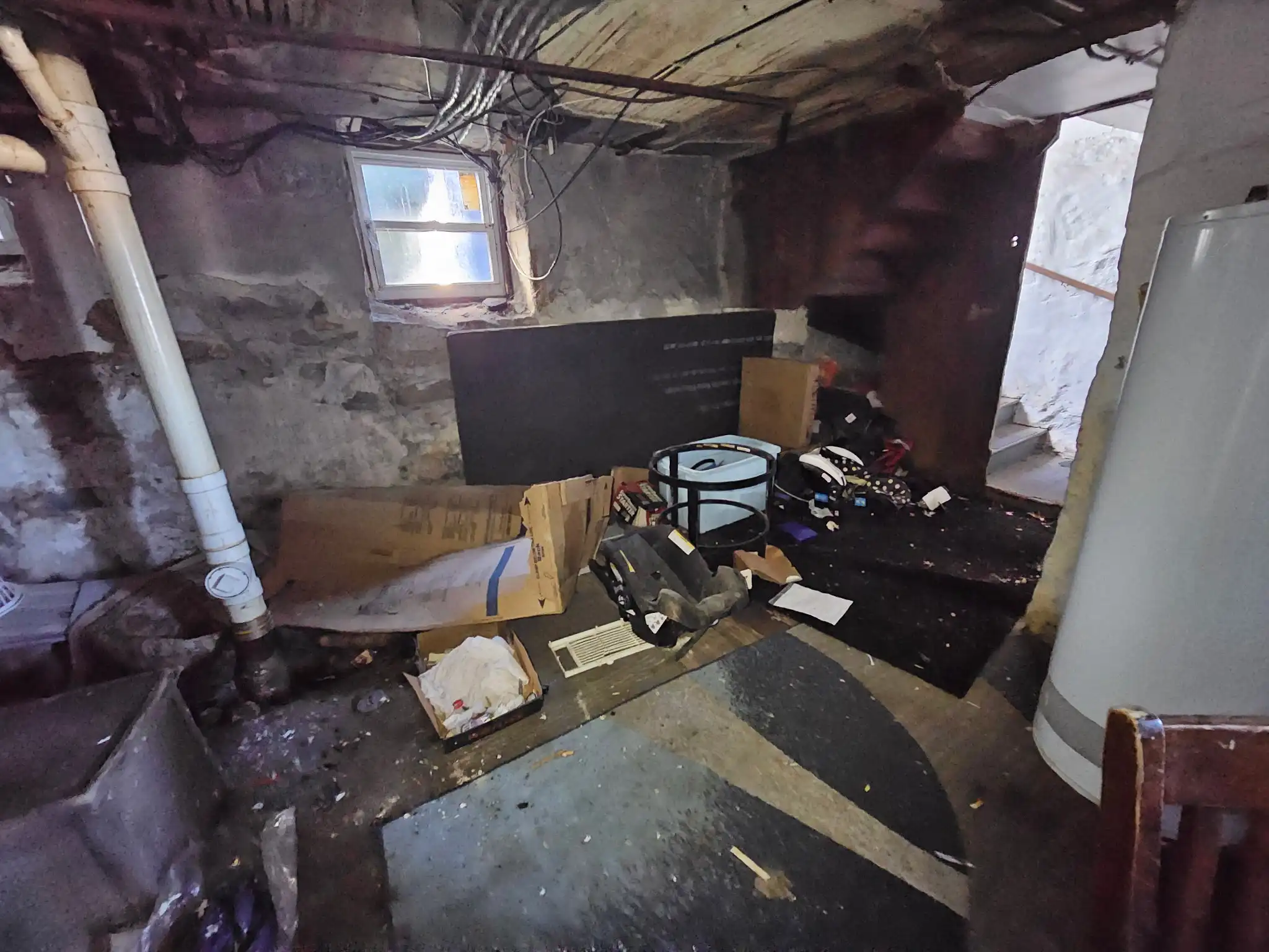 Basement cleanout before - cluttered storage space in New Bedford MA
